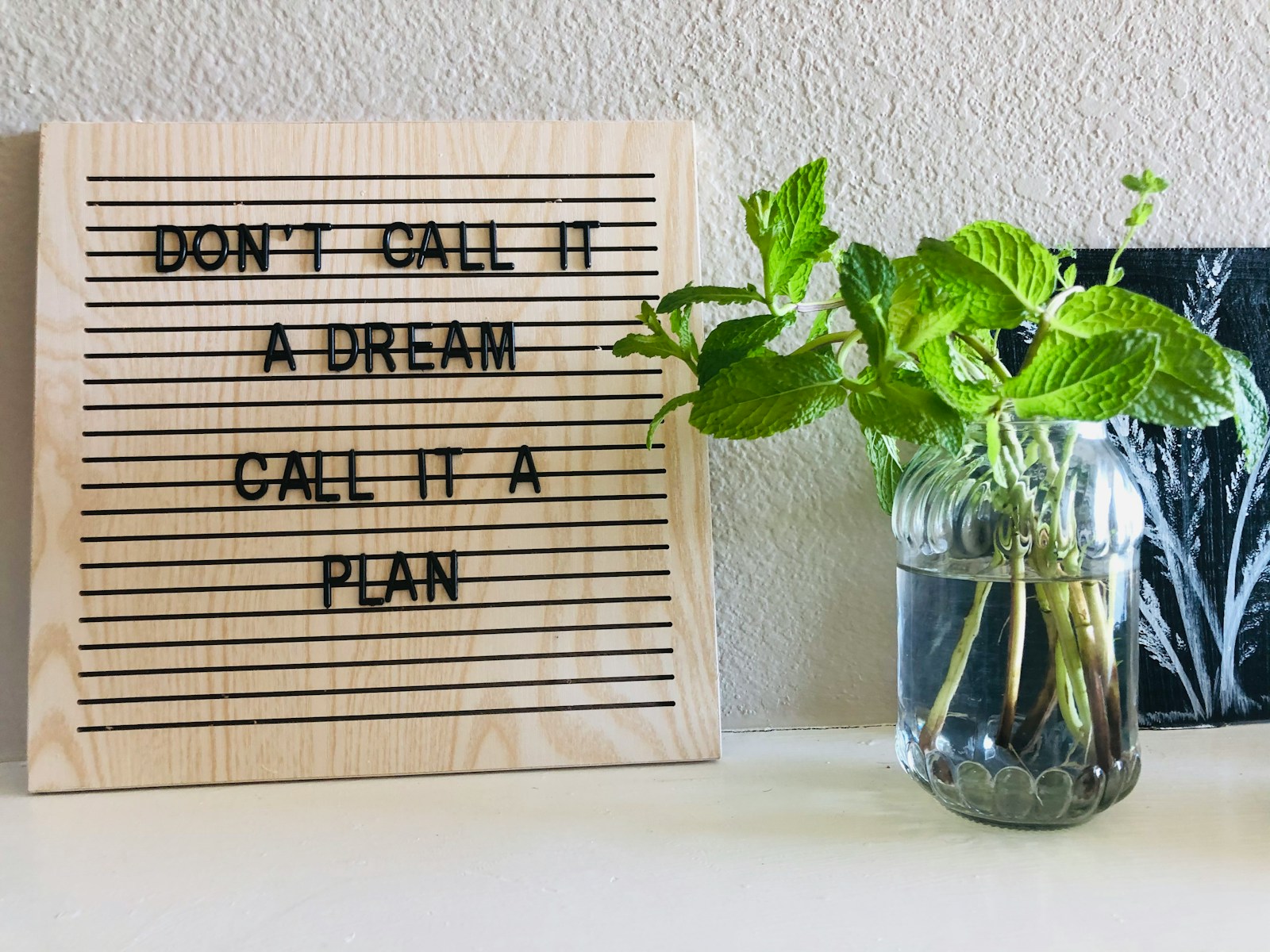 Photo by Madhuri Mohite brown wooden quote board on white wall
